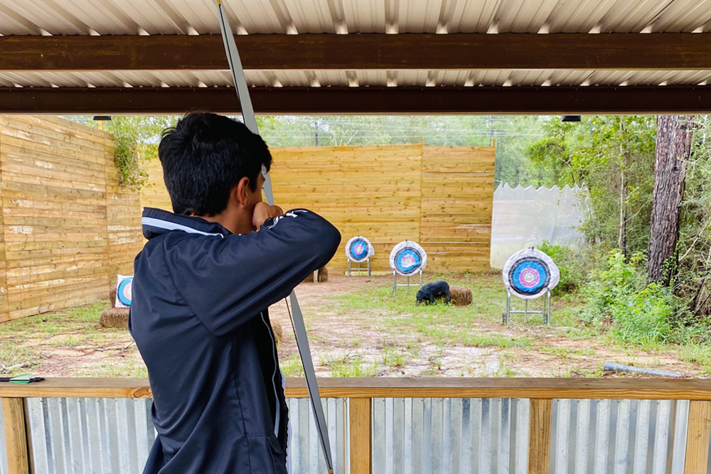 man shooting arrow